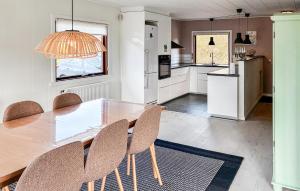 a kitchen and dining room with a table and chairs at 3 Bedroom Beautiful Home In Asperup in Asperup