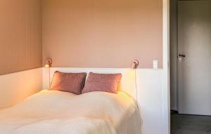 a bedroom with a bed with two pillows on it at 3 Bedroom Beautiful Home In Asperup in Asperup +9 photos