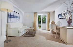 a living room with a white couch and a table at Hotel Villa Ceselle in Anacapri