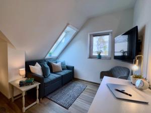 a living room with a couch and a table at INTERGO Apartments in Brackel