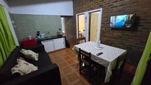 a living room with a couch and a table with a television at Departamentos Hernan in Apóstoles