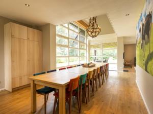 a large dining room with a long table and chairs at Achterhoek Villa with Heated Pool in Aalten