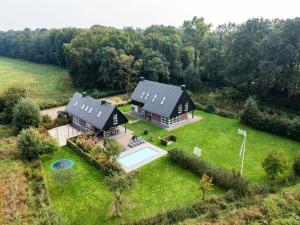an aerial view of a house with a swimming pool at Achterhoek Villa with Heated Pool in Aalten