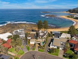 an aerial view of a beach with houses at Ocean Pines Apartment 5 in The Entrance +11 photos