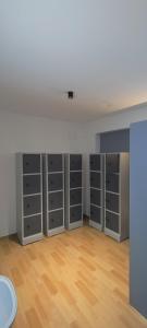 an empty room with grey lockers and a wooden floor at The Loft - Male Only in Chennai +11 photos