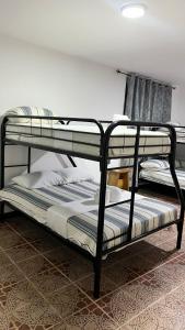 a couple of bunk beds in a room at Oasis Town in Carenero