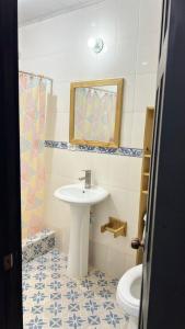 a bathroom with a sink and a toilet at Oasis Town in Carenero