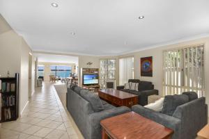 a living room with two couches and a table at Bluewater at Mannering Park in Mannering Park