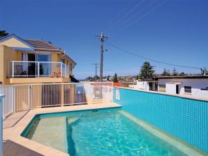 a swimming pool on the balcony of a house at Ocean Pines Apartments 4 in The Entrance