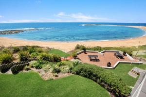 an aerial view of a house and the beach at Beachfront on Werrina in Blue Bay 
