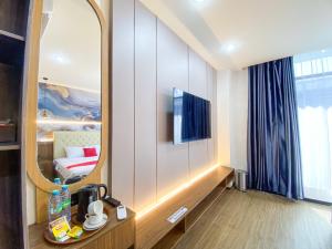 a hotel room with a mirror and a bed at RedDoorz Plus at edOtel Malang in Betek