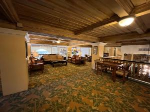 a living room with a couch and a table at The Green Room - Pool View with Parking Spot at 1920s Historic Residence with 24x7 Reception Desk on Palm Beach Island in Palm Beach