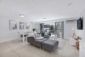 a living room with a couch and a table at Coast Apartments 19 Roof Top Pool in The Entrance