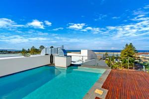 a swimming pool on the roof of a house at Coast Apartments 19 Roof Top Pool in The Entrance