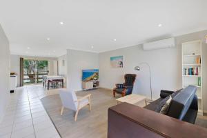 a living room with a couch and a table at Bonnieview House in Shelly Beach