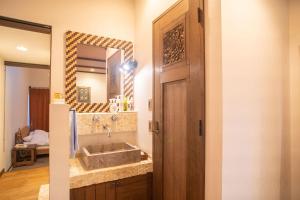 a bathroom with a sink and a mirror at Estivant Club in Tsumagoi +52 photos