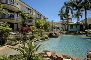 a swimming pool in front of a building at Allamanda Unit 22 in Long Jetty