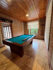 a billiard room with a pool table in it at Suites Casa ColibrÍ in Mindo