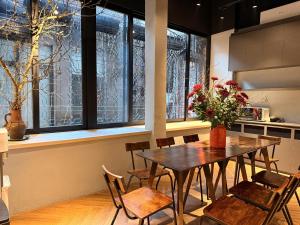 a dining room with a table and chairs and windows at Factor Inn - Old Quarter Centre in Hanoi +13 photos