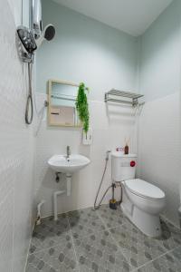 a bathroom with a toilet and a sink at An Ant House in Bangkok +33 photos