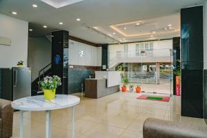 a lobby with a table with flowers on it at Keerthis Elite Hotel near Kempegowda international airport in Bangalore