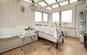 a bedroom with a bed and a table with flowers on it at 2 Bedroom Nice Home In Gedser in Gedser