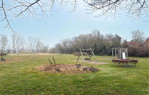 a park with a playground with a bench and a swing at 2 Bedroom Nice Home In Gedser in Gedser +14 photos