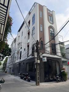 a building with motorcycles parked in front of it at Airport Homestay 2 in Danang