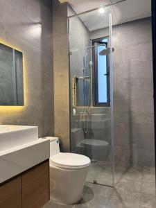 a bathroom with a toilet and a glass shower at Airport Homestay 2 in Danang