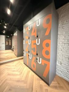 a wall with numbers on it in a room at Factor Inn - Old Quarter Centre in Hanoi