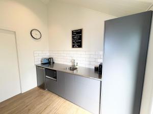 a kitchen with a sink and a clock on the wall at The Quarters Unit 2 - Lake Tekapo in Lake Tekapo