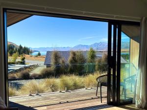 a sliding glass door with a view of a deck at The Quarters Unit 2 - Lake Tekapo in Lake Tekapo