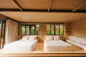 two beds in a room with two windows at 150 Peakway Mountain Resort in Dalaguete +76 photos