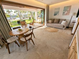 a living room with a table and chairs and a couch at Mint Lotus Resort - Koh Kood in Ban Bang Bao