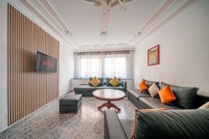 a living room with a couch and a table at Spacious Apartment 1 min from Beach in Tangier