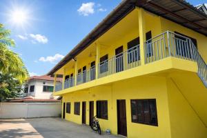 a yellow building with a balcony at Harmony Hotel in Vientiane