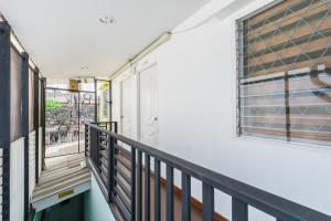 a balcony with a door and a window at An Ant House in Bangkok