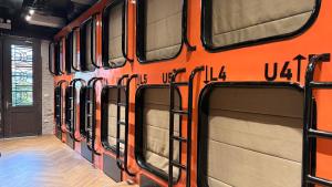 an orange bus is parked in a room at Factor Inn - Old Quarter Centre in Hanoi