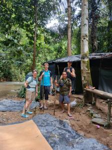 a group of people standing in front of a tent at Orangutan Inn in Bukit Lawang
