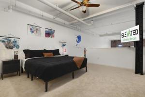 a bedroom with a bed and a ceiling fan at The Elevated Gallery - Historic Loft - Heart of Downtown - 98WalkScore in Denver