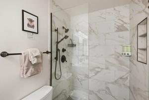 a bathroom with a shower with a glass door at The Elevated Gallery - Historic Loft - Heart of Downtown - 98WalkScore in Denver +84 photos
