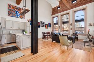 an open kitchen and living room in a loft at The Elevated Gallery - Historic Loft - Heart of Downtown - 98WalkScore in Denver