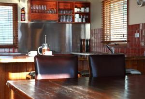a kitchen with a wooden table and two chairs at Cobungra Chalet in Mount Hotham