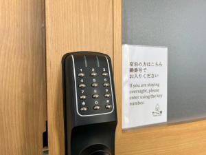a remote control sticking out of a door at たっこ宿 in Takko +18 photos