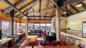 a living room with a couch and a table at Gundanora Chalet in Mount Hotham