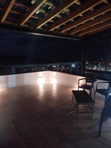 a room with two chairs and lights on a roof at Terra loft in Líbano
