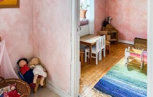 two dolls are laying on the floor of a room at 2 Bedroom Nice Home In Glömminge in Glömminge
