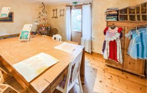 a dining room with a wooden table and a dresser at 2 Bedroom Nice Home In Glömminge in Glömminge