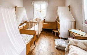 a room with several bunk beds and a window at 2 Bedroom Nice Home In Glömminge in Glömminge