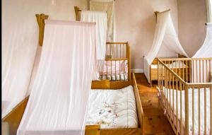 a room with two cribs and two babies at 2 Bedroom Nice Home In Glömminge in Glömminge +3 photos